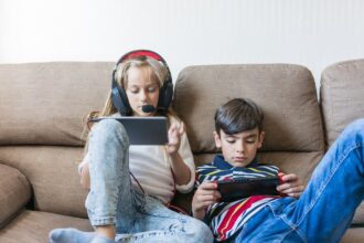 Niños juegan con consolas portátiles