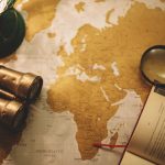 binoculars and magnifying glass on map