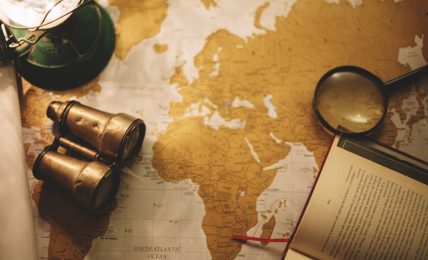 binoculars and magnifying glass on map