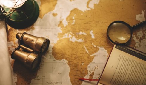 binoculars and magnifying glass on map