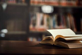 book in library with open textbook
