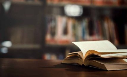 book in library with open textbook