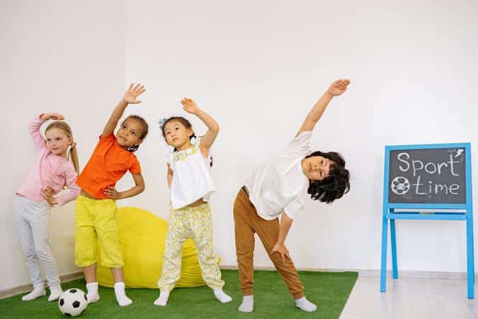 Niños de infantil haciendo ejercicio en clase.