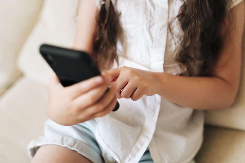 close up girl holding smartphone